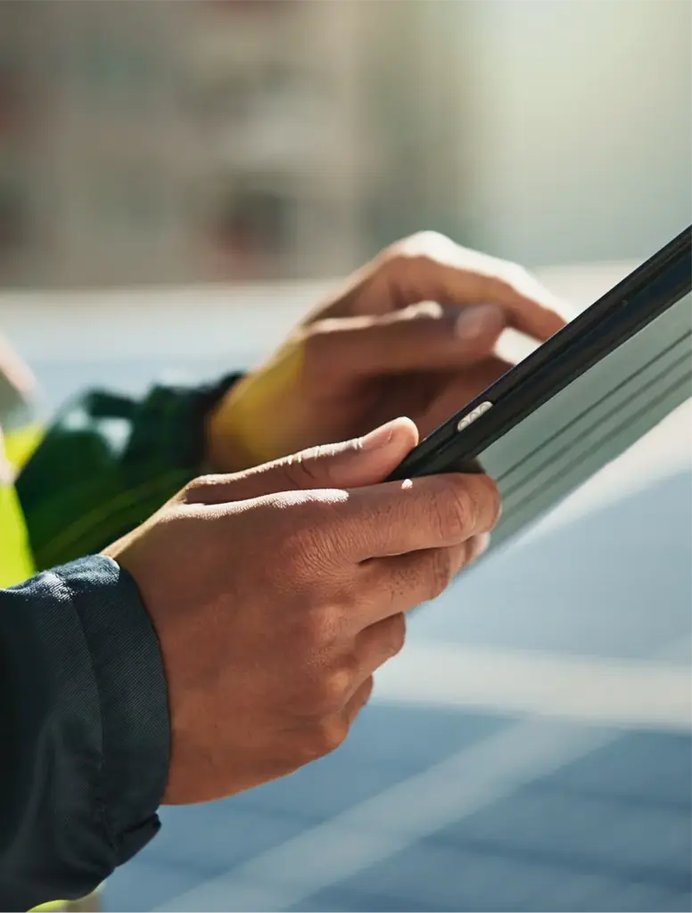 Man in PPF gear holding an iPad and tapping the screen.